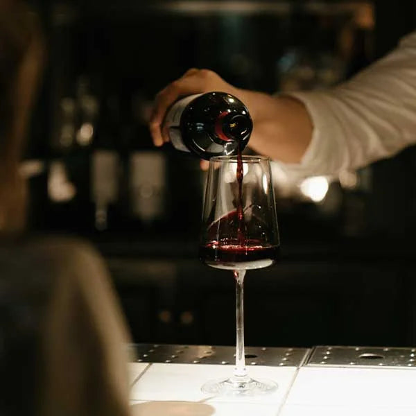 Bartender pouring a glass of wine