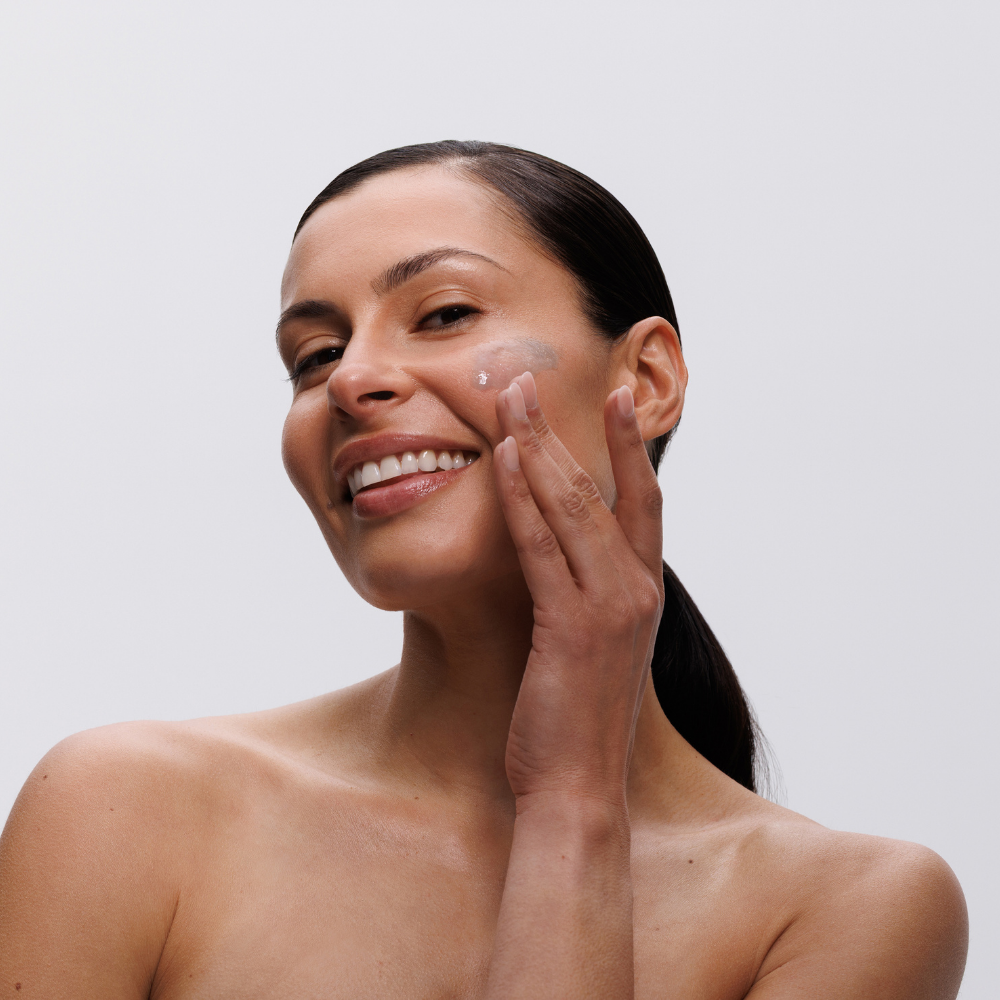 Skincare Model applying AlgiZome onto cheek