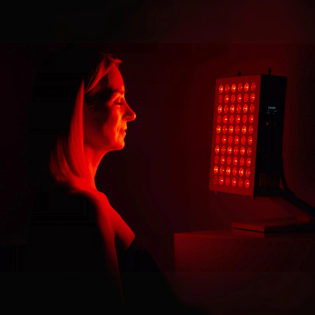Model standing in front Rojo 300 Red Light Therapy Device.