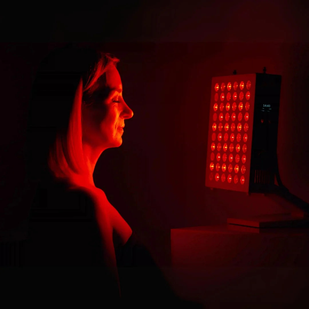 Model standing in front Rojo 300 Red Light Therapy Device.