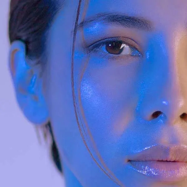 Person with blue light shining on face