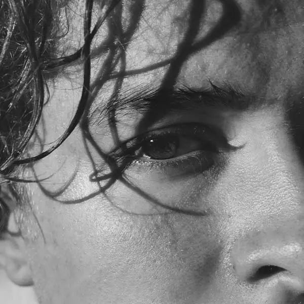 Black and white image of a man's close up face and eye area