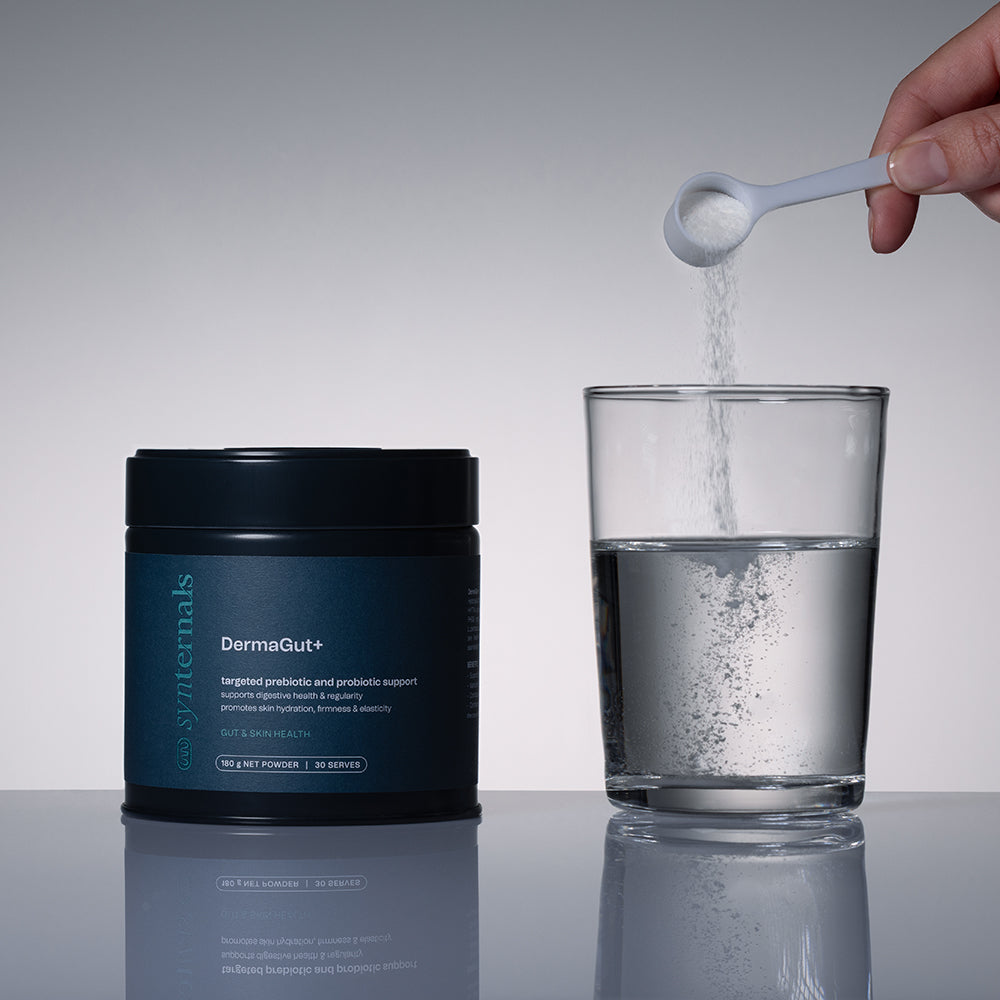 Model scooping DermaGut+ into glass of water