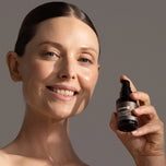 Model holding Ultimate A bottle