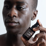Model holding Vitamin B bottle in their hand