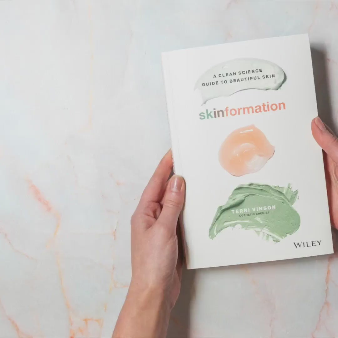 Hands flicking through pages of Skinformation A Clean Science guide to beautiful skin by Australian Skin Scientist Terri Vinson